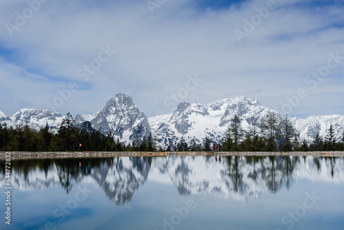 reflections in a mountain lake from a snowy mountain range in austria © thomaseder