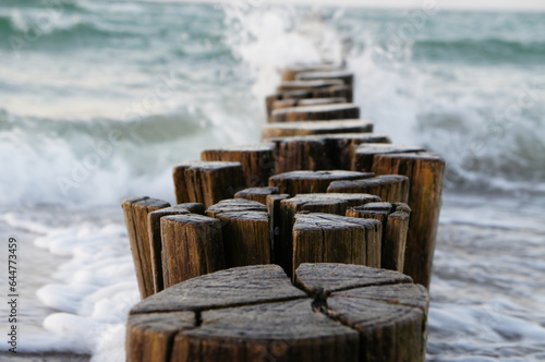 Fototapeta Naklejka Na Ścianę i Meble -  groynes jutting into the baltic sea. clouds shrouded with warm light atmosphere