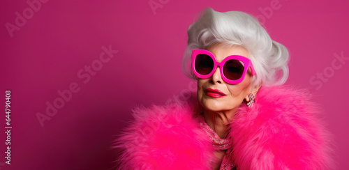 Elegant senior woman dons Barbie-style pink attire with timeless grace © Valeriia