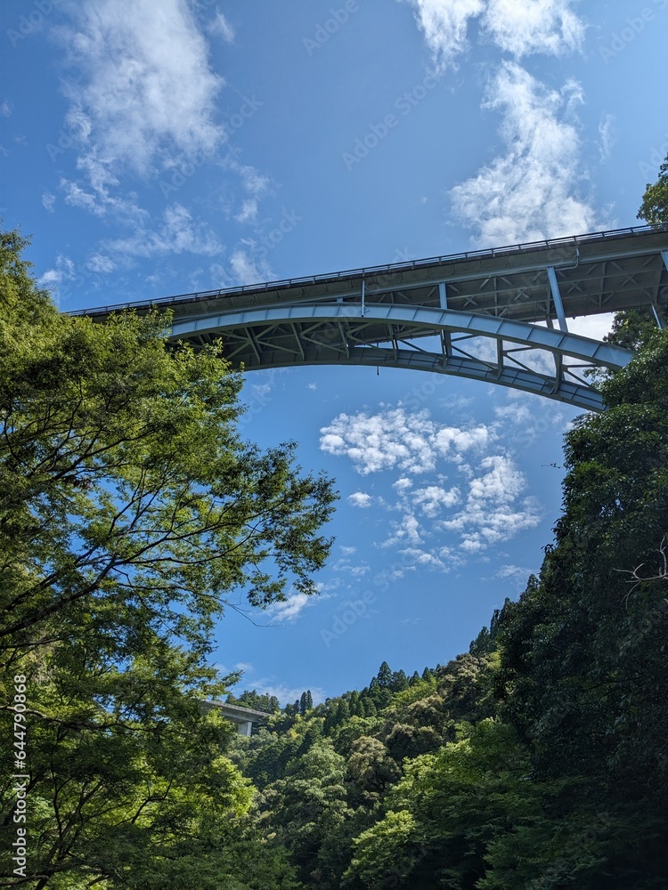 Takachiho Gorge, a narrow chasm cut through the rock by the Gokase River and partway along the gorge is the 17 meter high Manainotaki waterfall cascading down to the river below Takachiho Gorge, a narrow chasm cut through the rock by the Gokase River and partway along the gorge is the 17 meter high Manainotaki waterfall cascading down to the river below