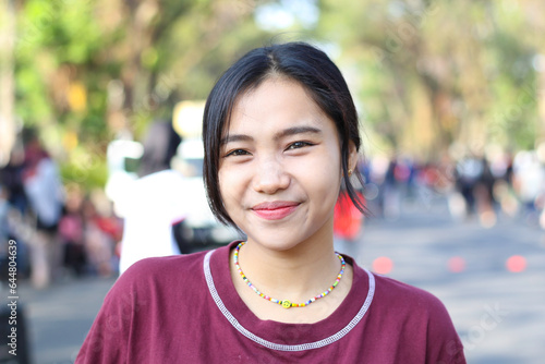 cheerful asian young woman smiling excited in the summer festival, music festival having fun with diverse people