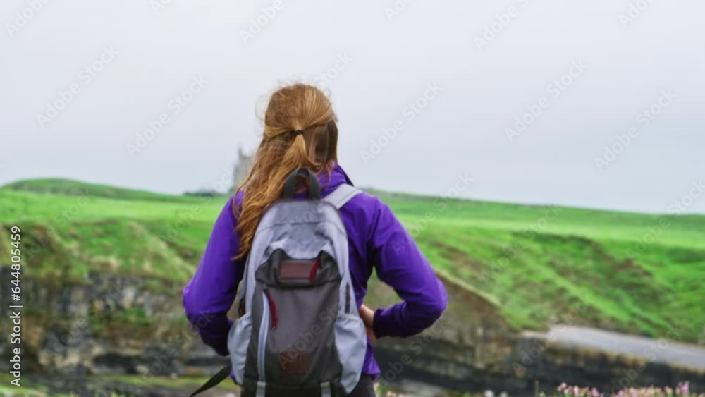 Woman Hiking Near Ireland Cliffside - Slow Motion Woman Hiking Near Ireland Cliffside - Slow Motion