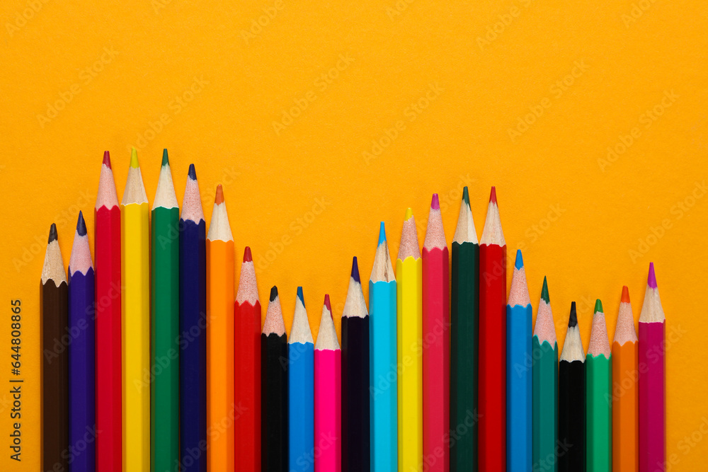 Colored wooden pencils on a yellow background. Colored wooden pencils on a yellow background.