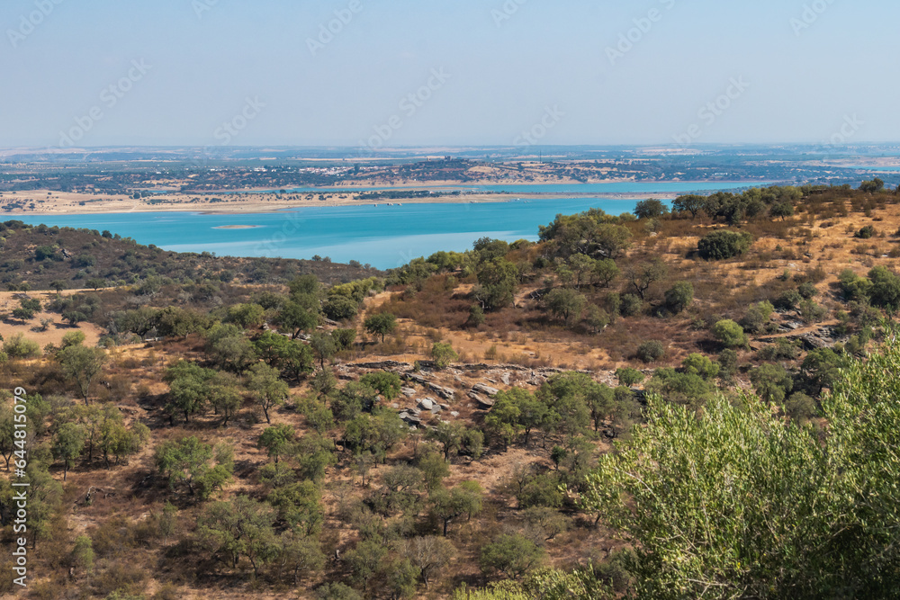 Trees in hill in viewpoint to Alqueva dam and mountains of Spain on the horizon, Monsaraz PORTUGAL