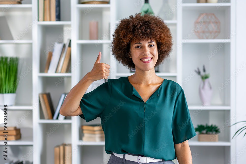 business, startup, people, gesture and teamwork concept - happy young african woman showing ok hand sign thumb up business, startup, people, gesture and teamwork concept - happy young african woman showing ok hand sign thumb up
