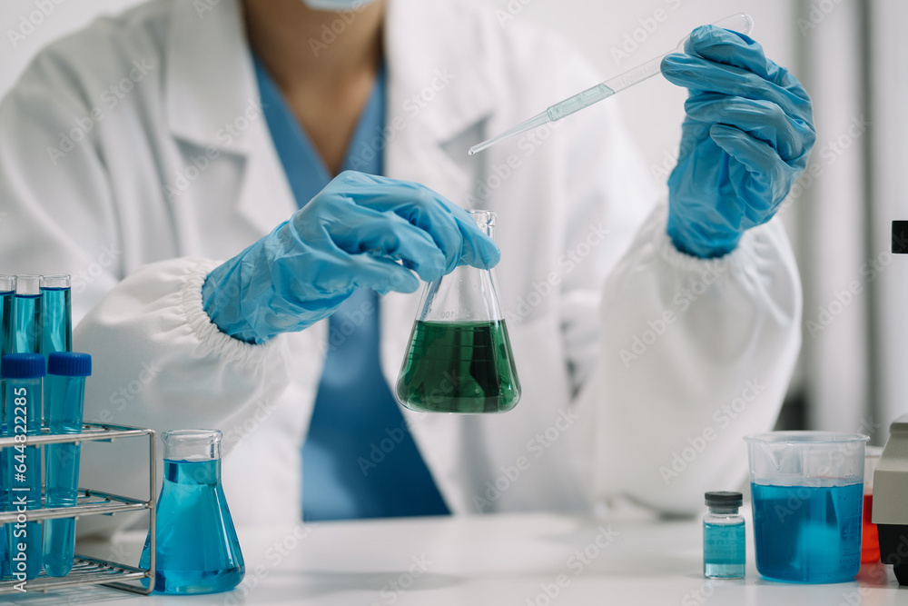 Female scientist researcher conducting an experiment working in the chemical laboratory. Female scientist researcher conducting an experiment working in the chemical laboratory.