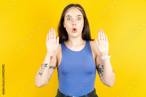 Beautiful woman wearing blue tank top Moving away hands palms showing refusal and denial with afraid and disgusting expression. Stop and forbidden. photo