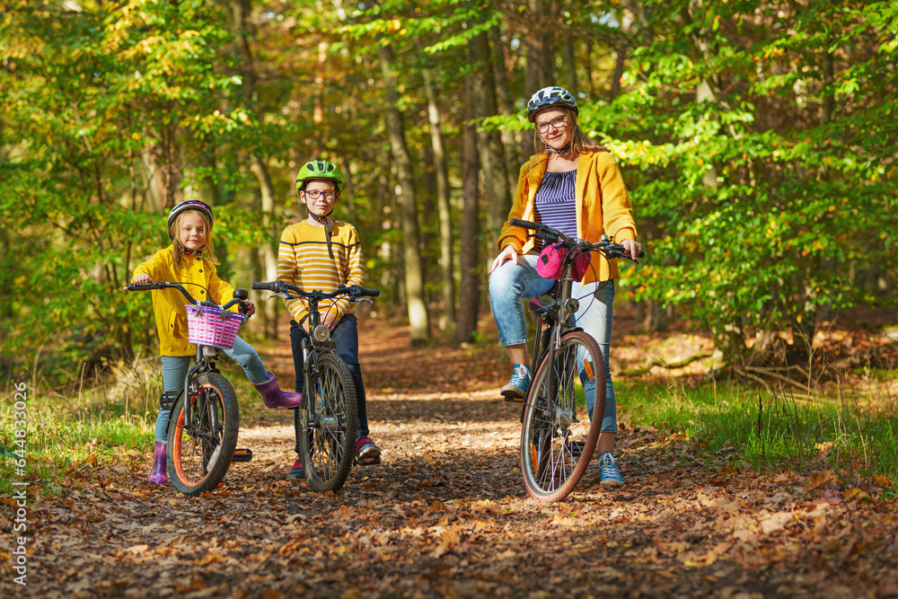 Young family with son and little daughter at bicycles, in the middle of autumn nature. Young family with son and little daughter at bicycles, in the middle of autumn nature.