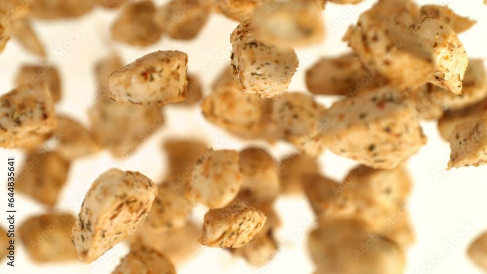 Super Slow Motion Shot of Tasty Chicken Bites Flying Towards Camera Isolated on White at 1000fps. Super Slow Motion Shot of Tasty Chicken Bites Flying Towards Camera Isolated on White at 1000fps.