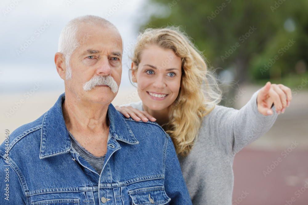 senior man and young woman in the park