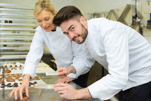 woman and man professional pastry cook at work
