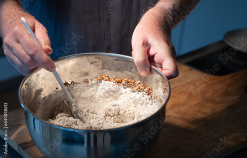 Dough preparation for a rustic grain bread. Mixing ingredients in a bowl.