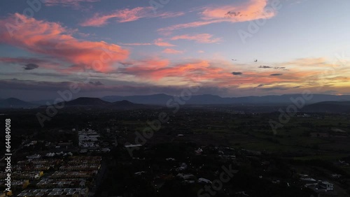 Wallpaper Mural Breathtaking drone video of a skyline in rural Mexico. 4K aerial view of colorful sunset with clouds above Cuernavaca, Morelos. Torontodigital.ca