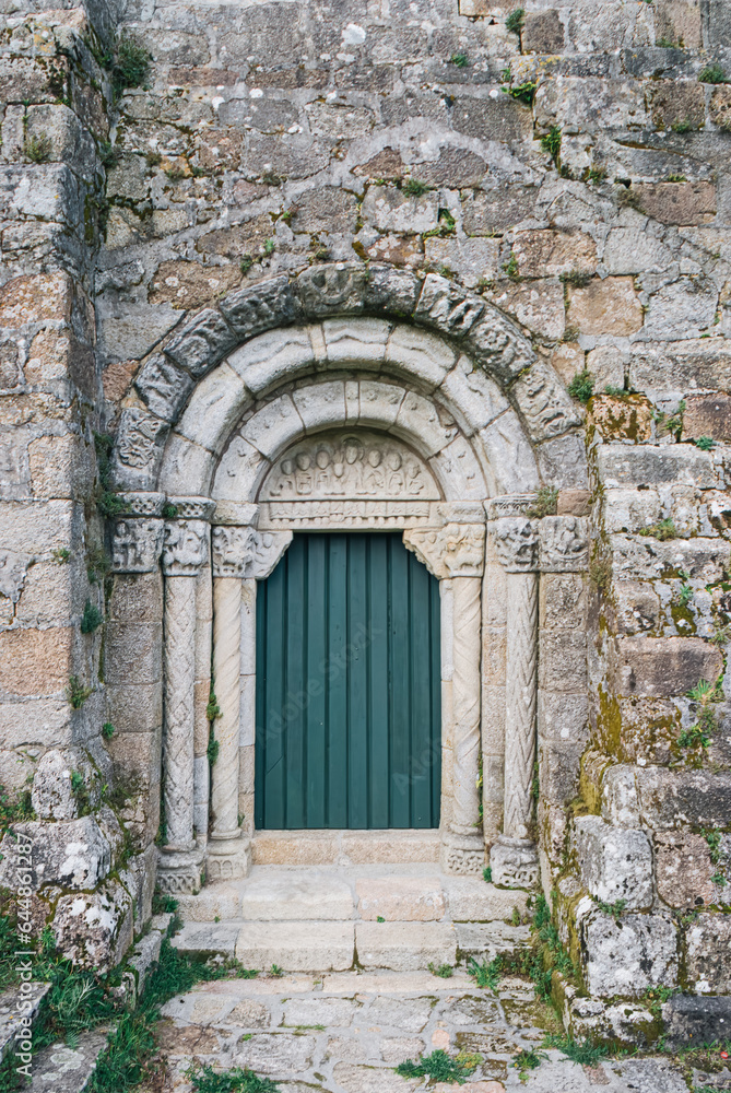 Old stone archway with green door, Santuario de San Xiao de Moraime, Muxia, Galicia, Spain