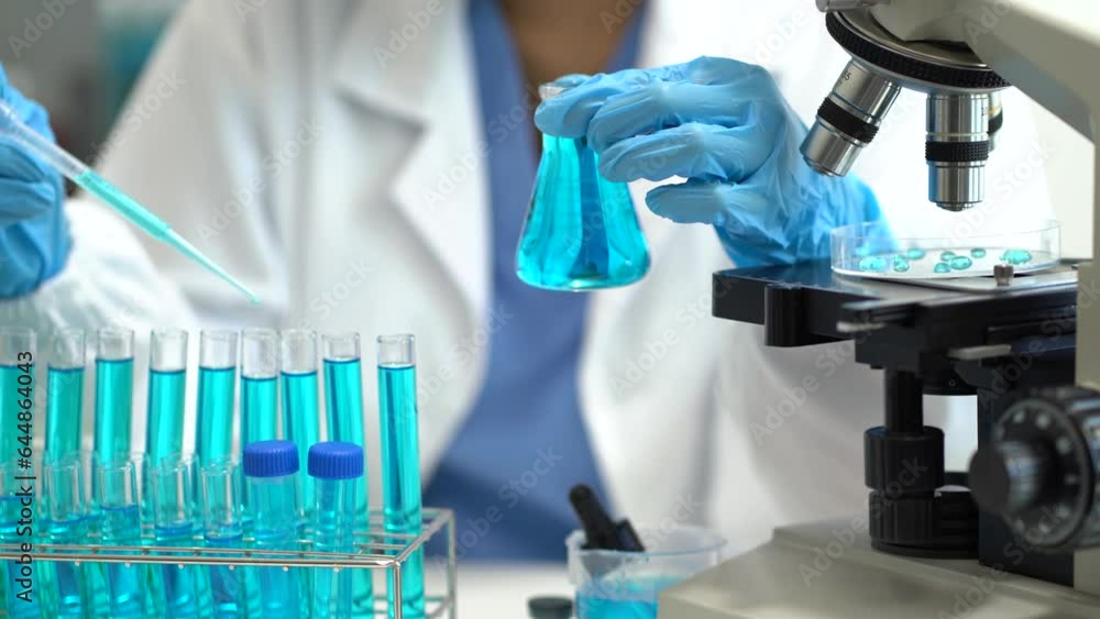 Scientist mixing chemical liquids in the chemistry lab. Researcher working in the chemical laboratory. Scientist mixing chemical liquids in the chemistry lab. Researcher working in the chemical laboratory.