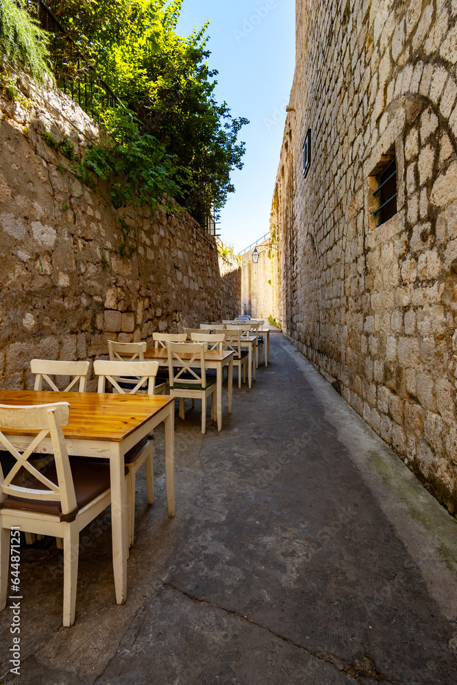 open-air cafe on the narrow street of the old town of Dubrovnik, croatia, vintage architecture, the concept of traveling through the Balkans