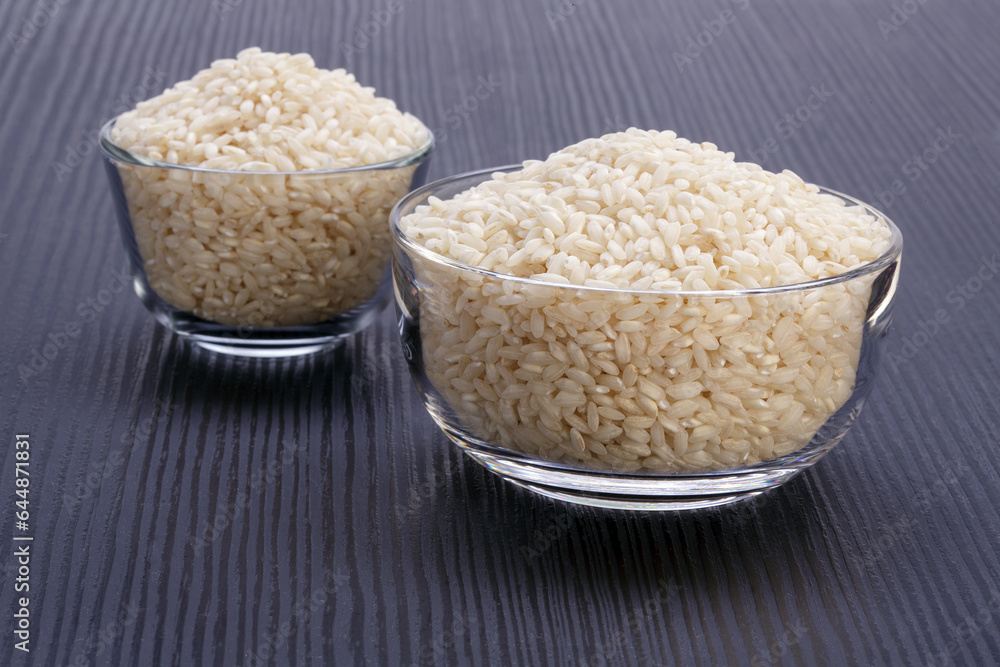 glass bowls with white rice on dark wooden table glass bowls with white rice on dark wooden table