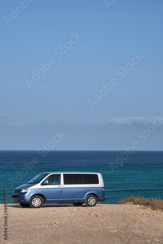 Van parked on beach © Elena