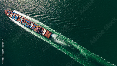 cargo container ship sailing full speed in sea to import export goods and distributing products to dealer and consumers worldwide, by container ship Transport, business logistic delivery service, © SHUTTER DIN