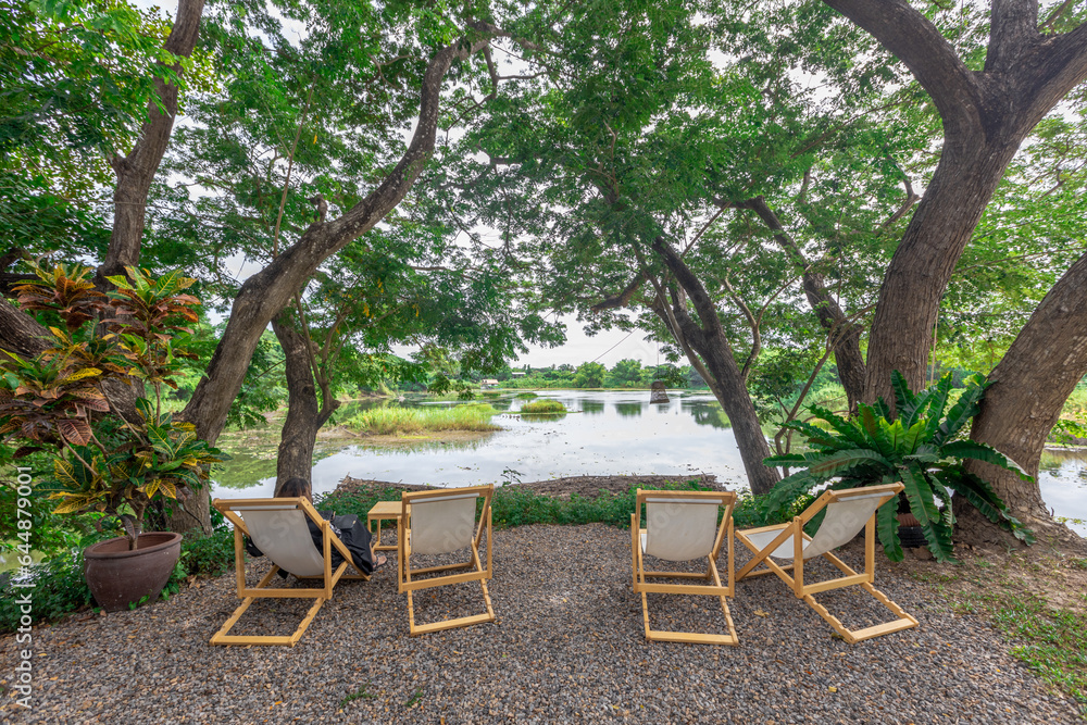 Background of wooden chairs or modern chairs that are placed in the interior of a restaurant or coffee shop for customers to sit while using the service. Background of wooden chairs or modern chairs that are placed in the interior of a restaurant or coffee shop for customers to sit while using the service.