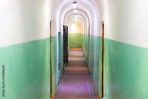 Corridor passage with doors and lights in empty tunnel