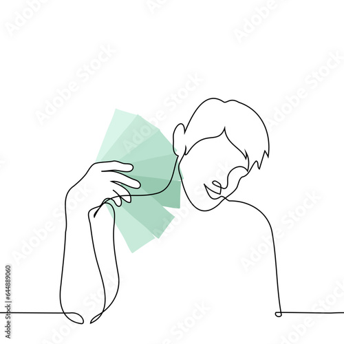 man smiling fanning stack of green banknotes - one line art vector. concept contentment with cash in hand, winnings, savings, salary, cashback