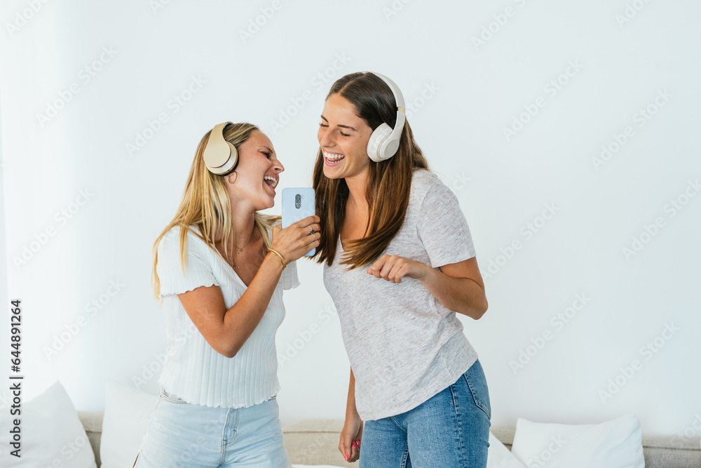 Cheerful women singing while listening to music