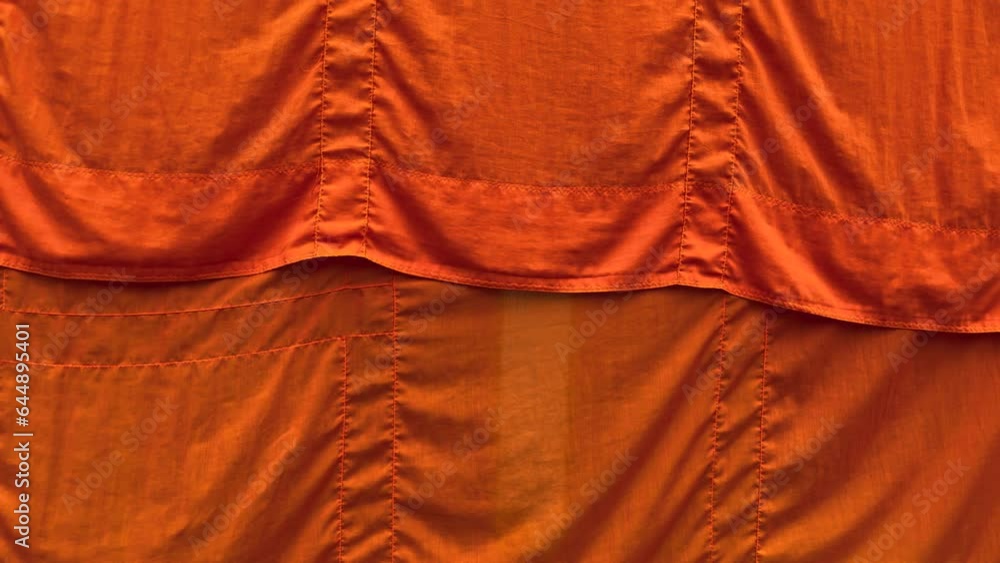Wind blowing yellow robe of buddhist monk hang dry in the temple ...