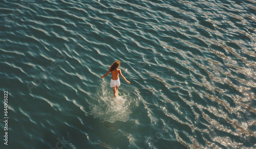 An AI-generated photo of a woman running on the open ocean surface. Celebration of a spirit of freedom. Boundless, unrestrained grace. Empowering essence of the breathtaking energy liberation.