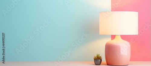 Contemporary table lamp featuring a small white lampshade isolated in isolated pastel background Copy space photo