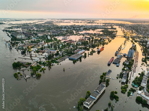 Undermining the dam of the Kakhovka reservoir. Consequences of the dam blowing. Flooded port infrastructure of the city of Kherson. Top view from above, aerial footage. Russian-Ukrainian war