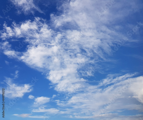 Day sky with white clouds on blue