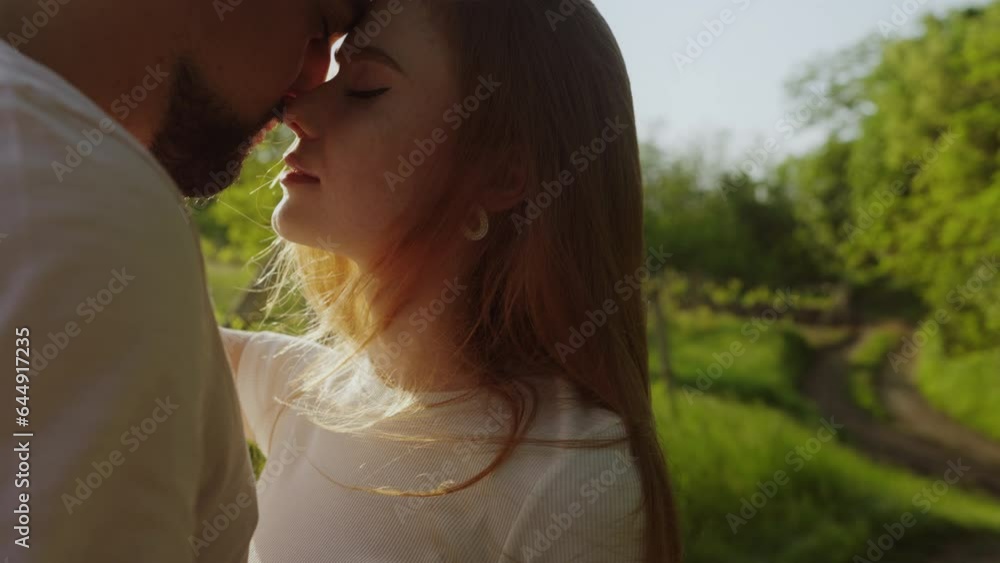 Couple with pensive faces standing close, closed eyes. Love and romantic concept. Couple in love with sunset on background. Couple with pensive faces standing close, closed eyes. Love and romantic concept. Couple in love with sunset on background.