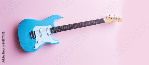 Blue guitar against isolated pastel background Copy space photo