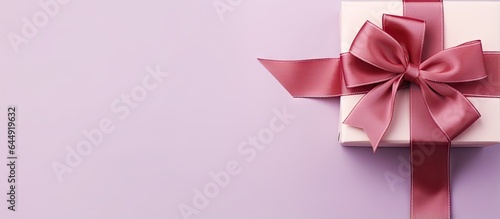 Red box with purple bow on a isolated pastel background Copy space