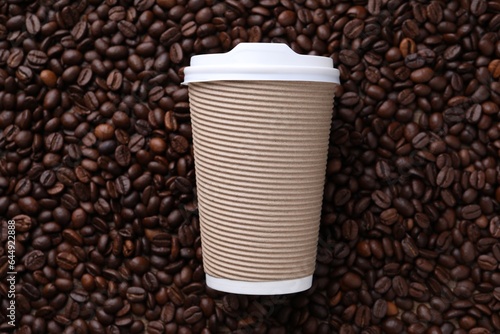 Coffee to go. Paper cup on roasted beans, top view