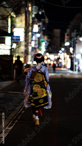 japanese geisha walking down busy night road