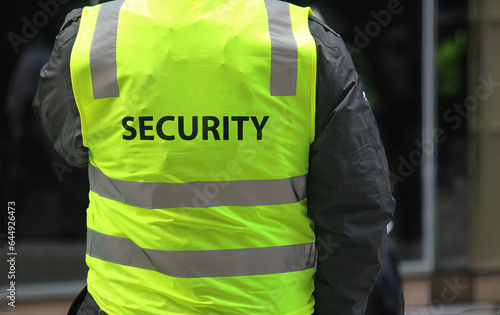 A security guard wearing a high vis vest