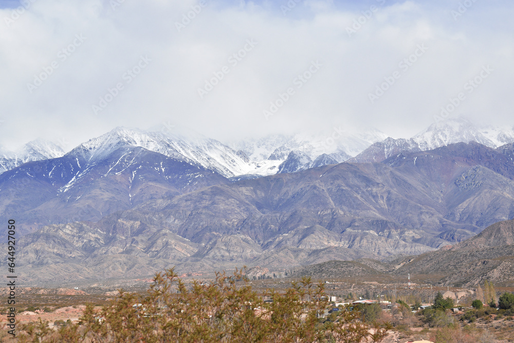 the andes mountain range in mendoza argentina with imposing mountains and snow-capped peaks.