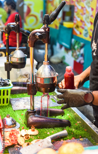 Process of making pomegranate juice in Jalan Alor street food in Malaysia