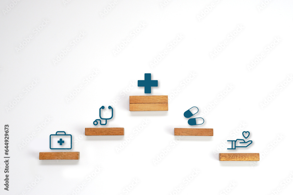Medical icon symbol on a wooden block cube arranged in steps. Health care, health insurance and treatment concept. Medical icon symbol on a wooden block cube arranged in steps. Health care, health insurance and treatment concept.