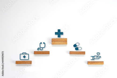 Medical icon symbol on a wooden block cube arranged in steps. Health care, health insurance and treatment  concept.