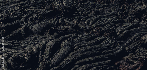 The lava surface cools and hardens into rock Clumps of dark black lava