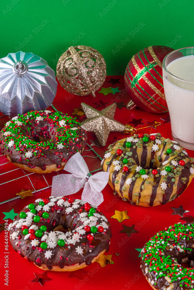 Bright festive decorated Christmas and New Year donuts set, with colorful red, green white snowflake sugar sprinkles. Sweet seasonal Christmas dessert