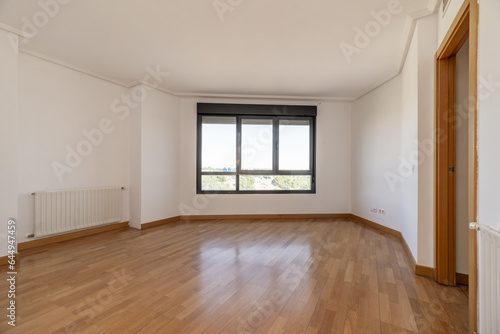 An empty living room with cheap radiators © Toyakisfoto.photos