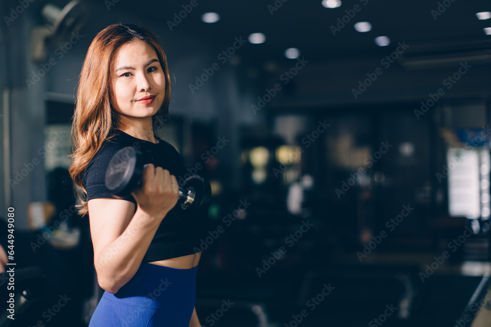 Portrait Happy sport Asian woman bodybuilding advertising athlete model muscle training in fitness gym sport club