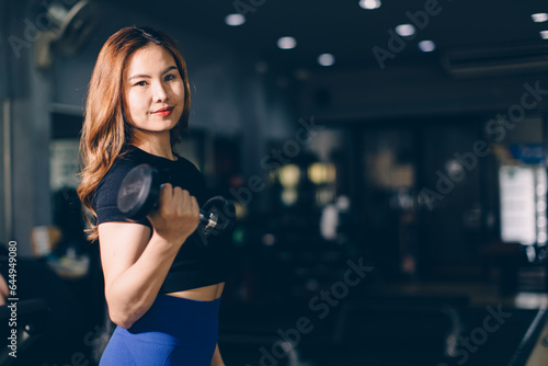 Portrait Happy sport Asian woman bodybuilding advertising athlete model muscle training in fitness gym sport club