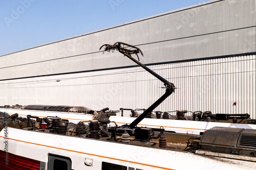Close up of a raised pantograph on an electric train