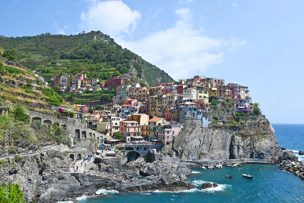 Famous colorful village Riomaggiore sitting on high cliffs at Cinque Terre coast, Italy