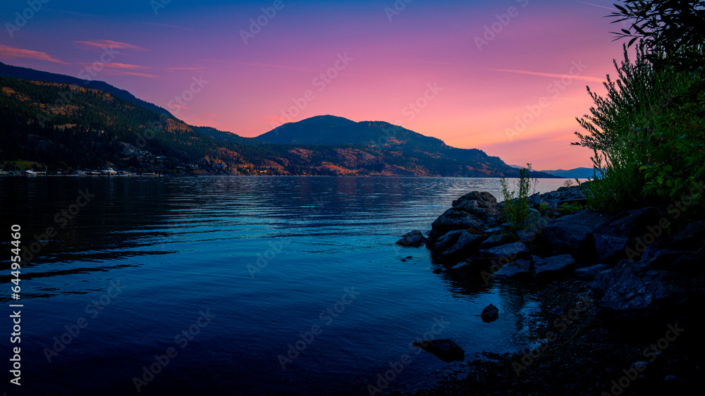 Kelowna skyline at sunset over Okanagan Lake in British Columbia, western Canada, Okanagan Valley Wine Country landscape Kelowna skyline at sunset over Okanagan Lake in British Columbia, western Canada, Okanagan Valley Wine Country landscape